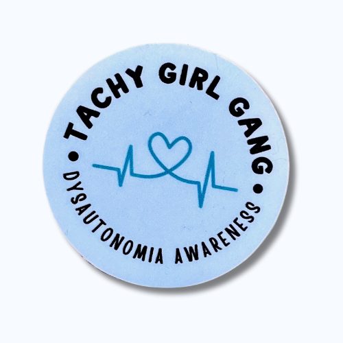Round blue sticker with black text reading “Tachy Girl Gang” across the top and “Dysautonomia Awareness” across the bottom, featuring a light teal heart with a heartbeat line in the center.